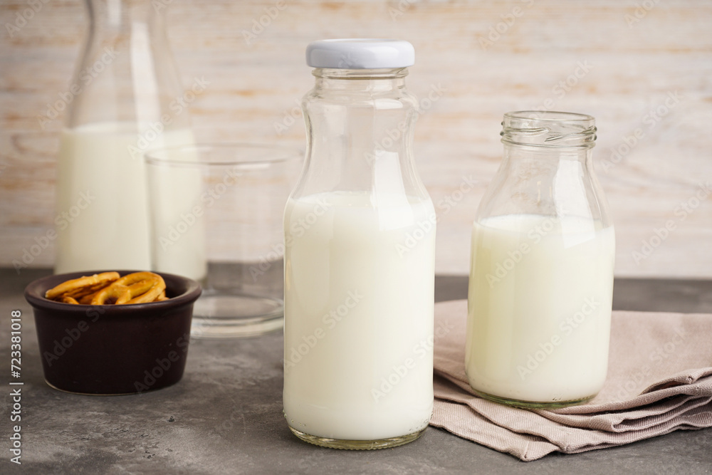 Milk in jar and glass on the grey background. Milk in jar and glass on the grey background.