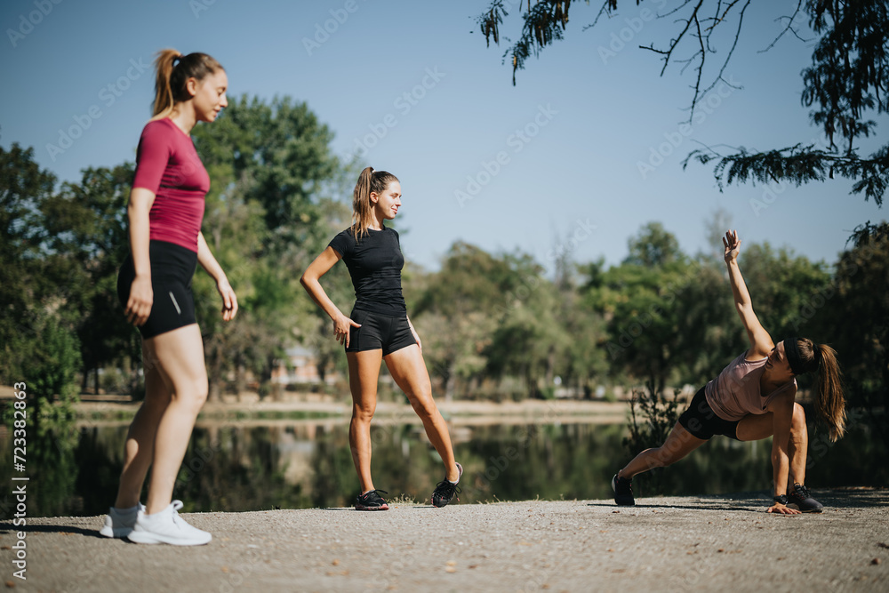 Fit girls enjoying outdoor sports, stretching and warming up in a city park. Friends staying active and getting in shape together. Fit girls enjoying outdoor sports, stretching and warming up in a city park. Friends staying active and getting in shape together.