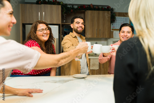 Businesspeople making a toast with their coffee cups during a work break