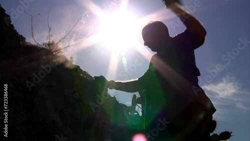 A man chisels rocks in the desert.