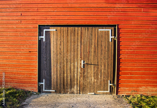 Wooden gate, entrance to a wooden barn, red wooden wall, village life photo