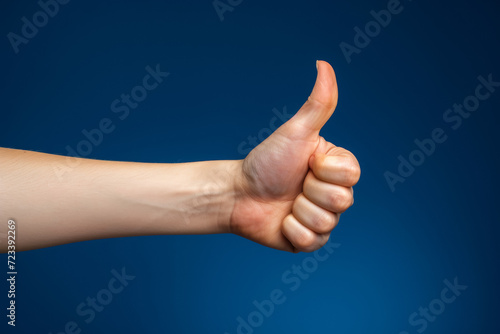 Thumbs up gesture in studio, advertising concept. Background with selective focus and copy space