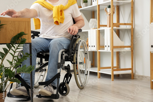 Man in wheelchair working a...