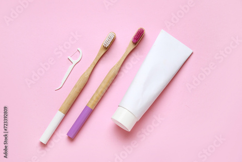 Toothbrushes, floss toothpick and toothpaste on pink background. World Dentist Day