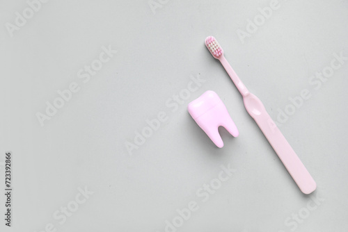 Tooth model with electric toothbrush on white background. World Dentist Day © Pixel-Shot