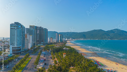 Aerial sunset view of Da Nang coastline. My Khe beach seafront with high-rise hotels and skyscrapers in the golden sand beach