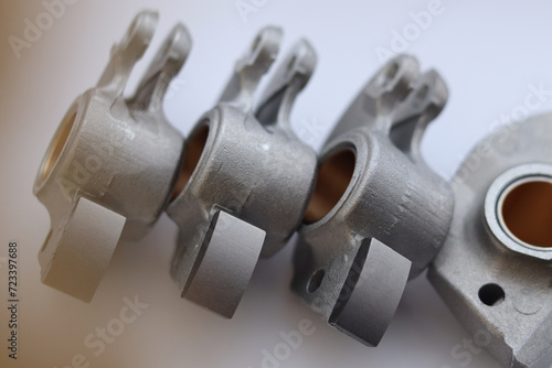 Aluminum light-alloy rocker arms with working surfaces for contact with camshaft.