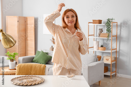 Mature woman in pajamas app...