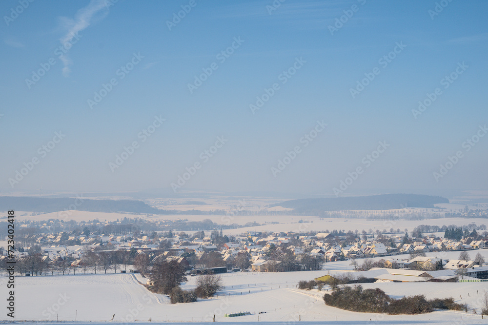 Winter landscape with snow covered hills and blue sky. Beautiful winter background.