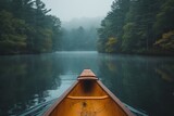A tranquil fog hovers over the serene lake as a lone canoe glides through the mist, surrounded by towering trees and majestic mountains, offering a peaceful journey through the heart of nature