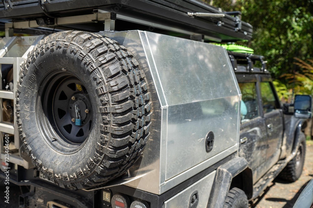 Camper trailer connected to a white car. SUV pulling a camper trailer with safety chains and wiring corrector Camper trailer connected to a white car. SUV pulling a camper trailer with safety chains and wiring corrector