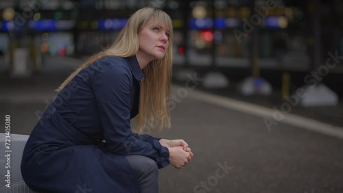 Sad Blond Woman Worried Thinking About Life Problems at Trainstation photo