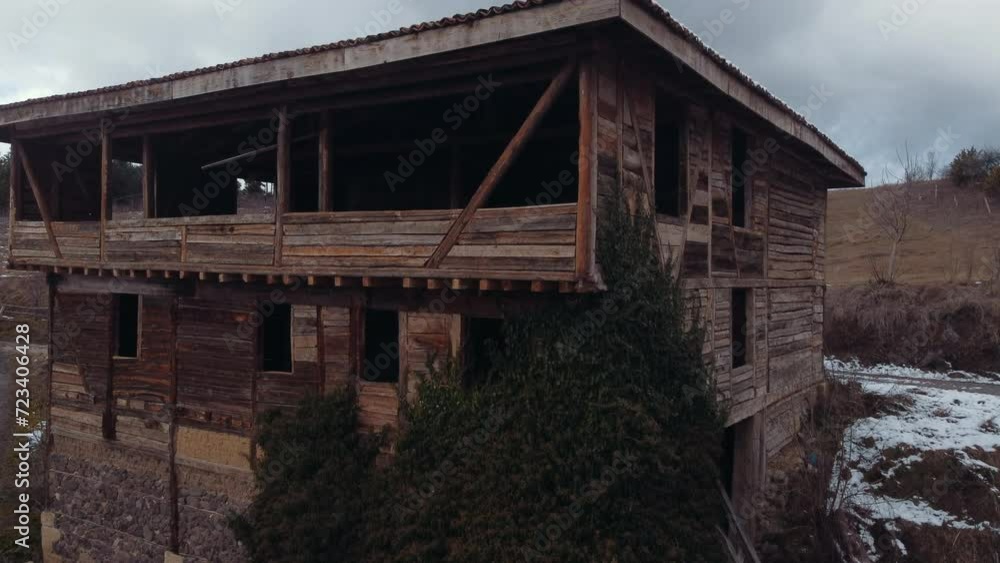An old wooden village house is being restored. It's winter days and there is snow on the roof. An old wooden village house is being restored. It's winter days and there is snow on the roof.