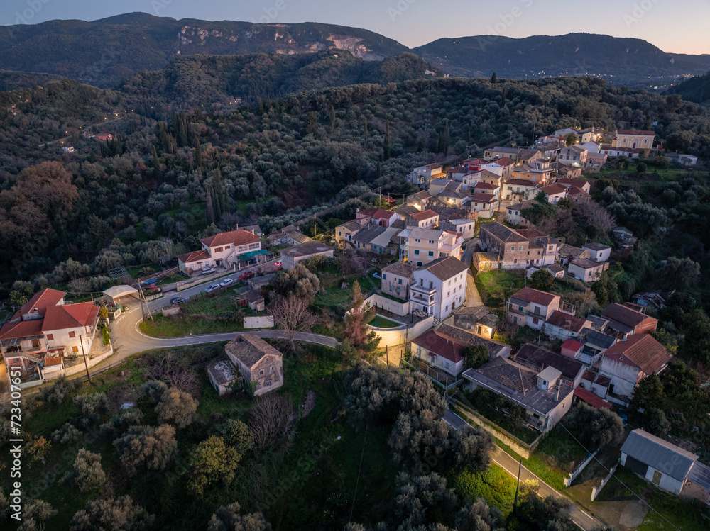 Greece, mountain village Drosato aerial panoramic view, Corfu. Traditional tile roof and stone wall buildings, forest trees, winter