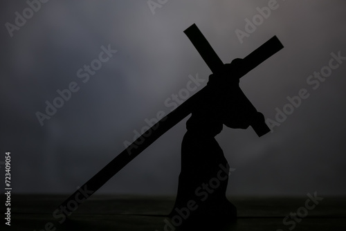 Canvas Print Jesus carrying wooden cross on grey background