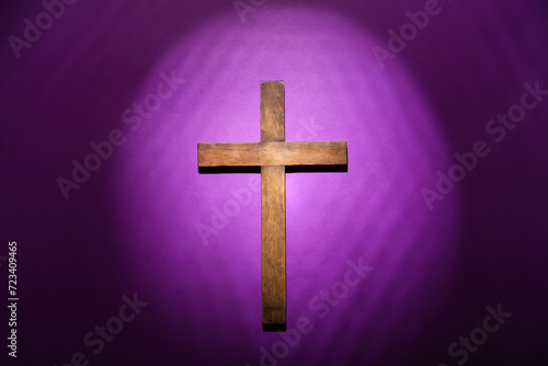 Wooden cross on purple background. Good Friday concept