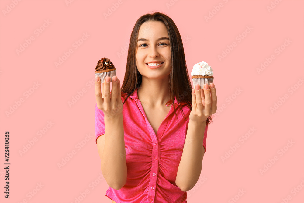 Young woman with sweet cupcakes on pink background. Valentine's Day celebration Young woman with sweet cupcakes on pink background. Valentine's Day celebration