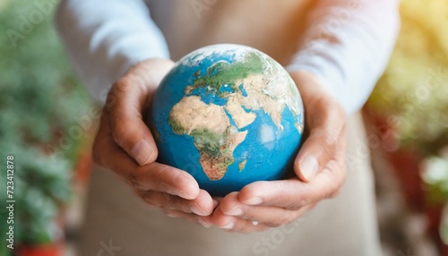 Hands holding earth. Concept of protecting the world from global warming. Sustainability topic to save the world. 