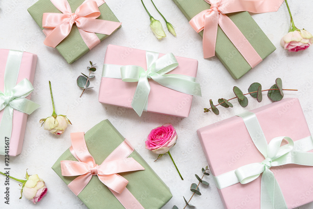 Gift boxes with beautiful roses and eucalyptus on white background. International Women's Day Gift boxes with beautiful roses and eucalyptus on white background. International Women's Day
