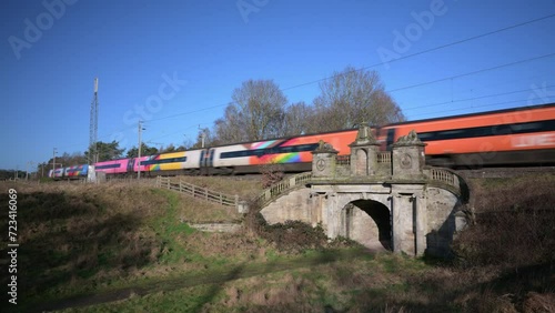 COLWICH, STAFFORDSHIRE, ENGLAND - JANUARY 26 2024: Passenger train travelling over a railway bridge on the West Coast mainline railway. photo