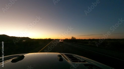 Driving at sunrise on an interstate highway through the desert of Arizona photo
