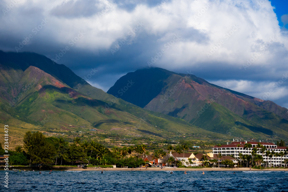Photo of Maui, Hawaii from the ocean. Lahaina before the fire. Clouds forming over Maui Island Photo of Maui, Hawaii from the ocean. Lahaina before the fire. Clouds forming over Maui Island