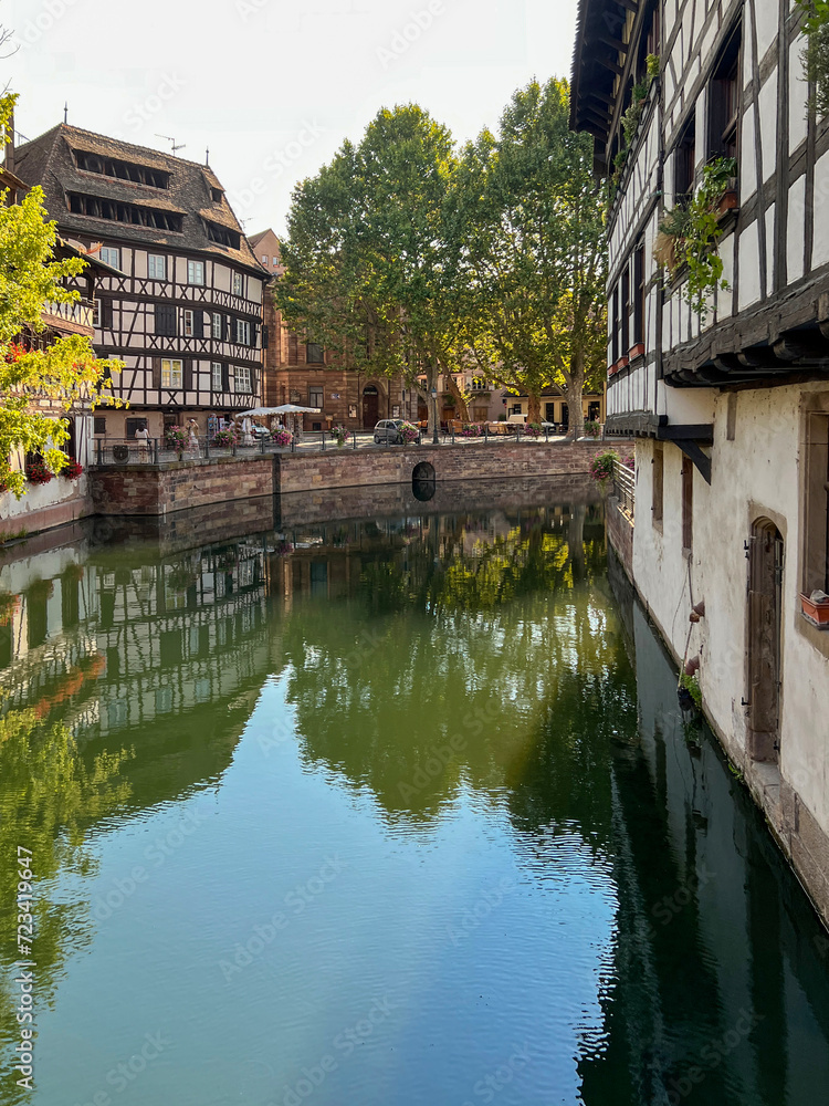 Charming historical half-timbered buildings on the canal in the heart of Strasbourg, France. The canal reflect the scene. A UNESCO World Heritage Site.