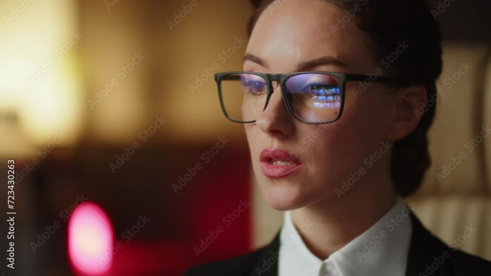 Reflection at glasses young woman content manager reviewing her profile on stock photos account. Professional designer choosing best illustrations for project. Watching some videos Reflection at glasses young woman content manager reviewing her profile on stock photos account. Professional designer choosing best illustrations for project. Watching some videos