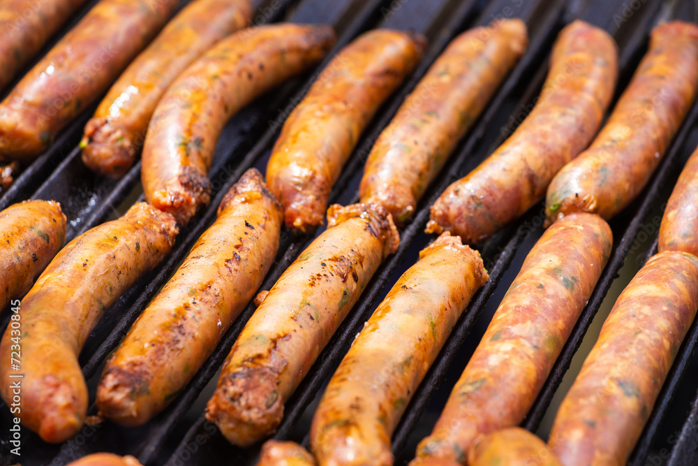 Group chorizos on the grill, traditional Colombian food Group chorizos on the grill, traditional Colombian food