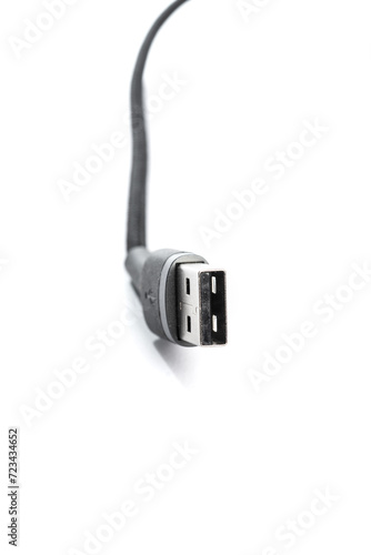 Black USB braided cable - Lightning isolated on a white background, close -up. (selective focus)