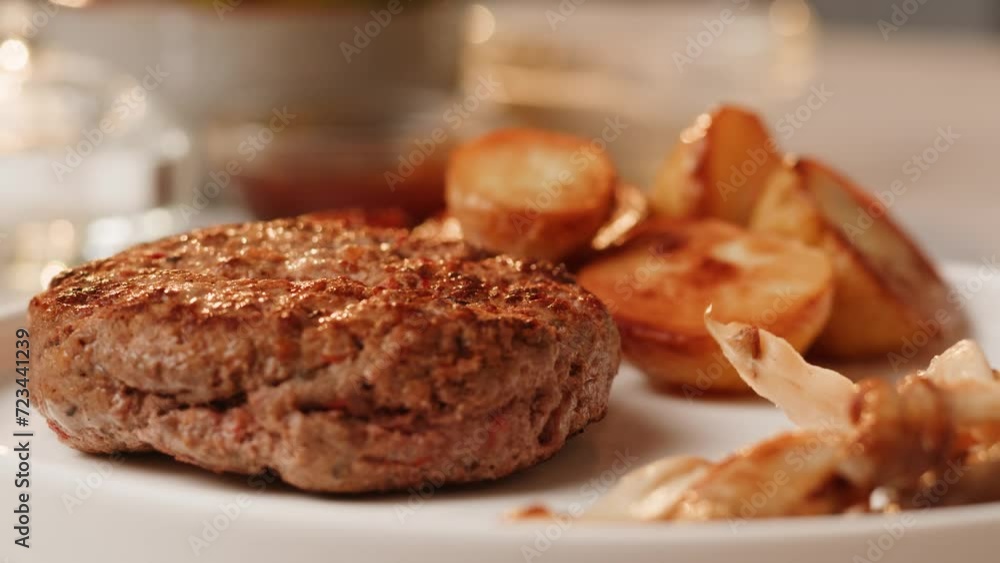 Close up of delicious grilled beef steak medallions served on table with potato and mushrooms, and coleslaw. Close up of delicious grilled beef steak medallions served on table with potato and mushrooms, and coleslaw.