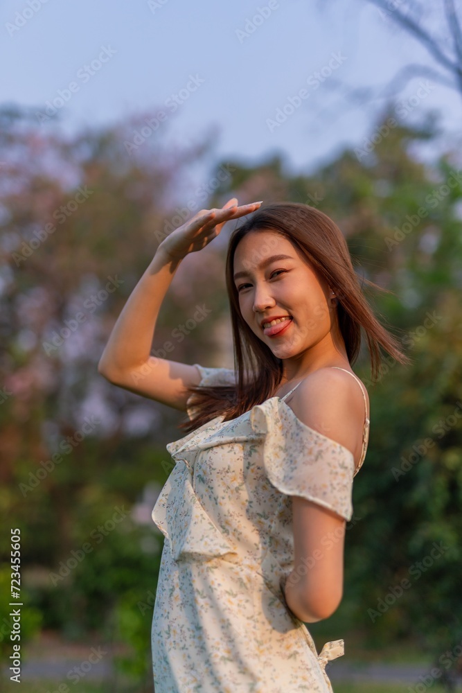 Beautiful young asian woman enjoying nature and sunset breeze at a park Beautiful young asian woman enjoying nature and sunset breeze at a park