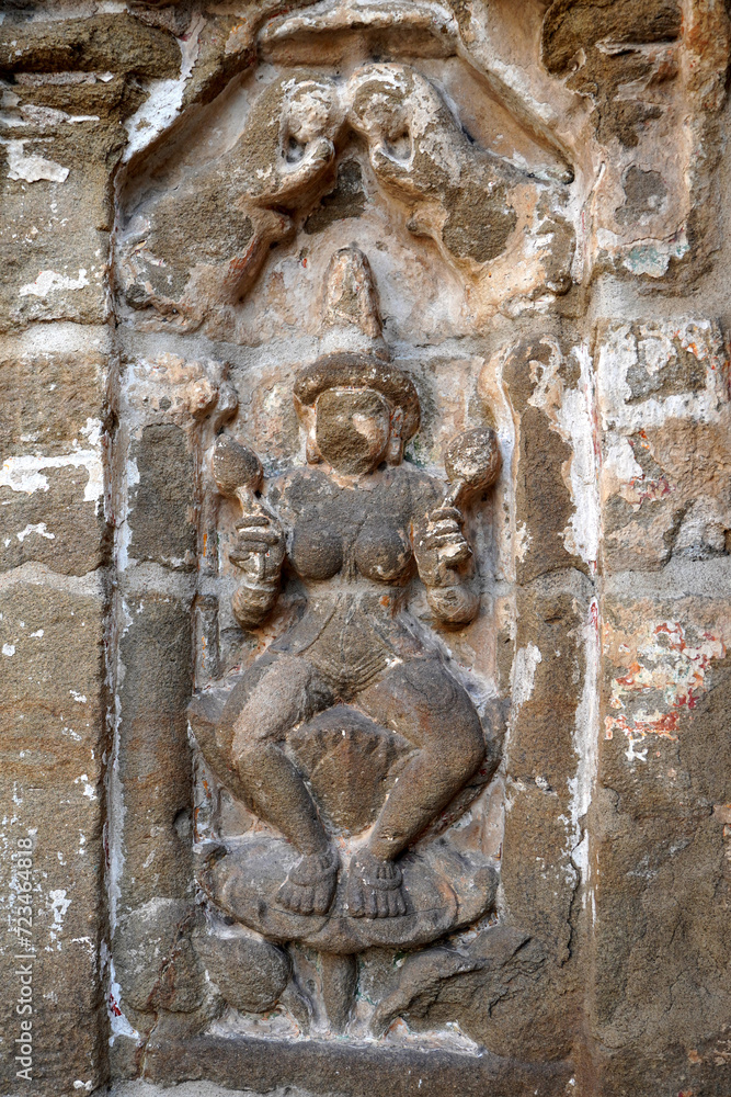 Bas relief of Hindu deity Sandstone sculpture. Ruins of ancient sculptures carved in the walls of Kanchi Kailasanathar temple in Kanchipuram, Tamilnadu.