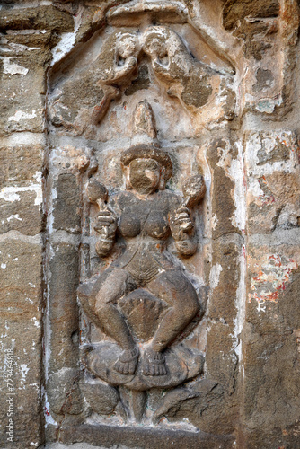 Bas relief of Hindu deity Sandstone sculpture. Ruins of ancient sculptures carved in the walls of Kanchi Kailasanathar temple in Kanchipuram, Tamilnadu.