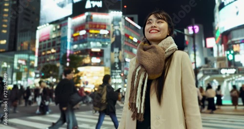 Night, walking and Japanese woman in town for exploring on vacation, adventure or holiday. Happy, travel and beautiful Asian female person by public transport for sightseeing on weekend trip in city photo