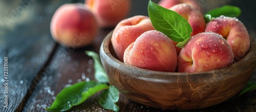 Fresh organic peaches in a wooden bowl, harvested for food or juice.