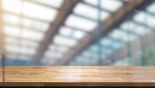 Wood table top on blur glass window wall building background. For montage product display or design key visual layout background. banner template ready to use