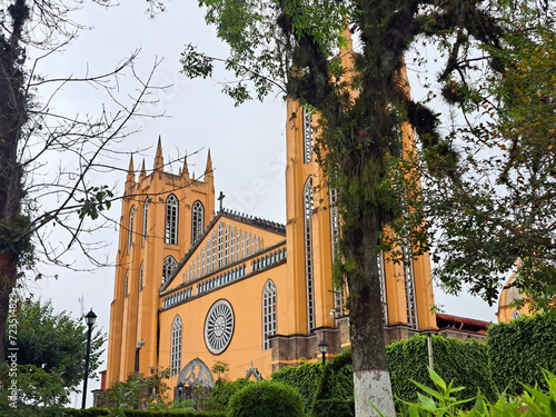 Parish of San Juan Bautista in front of the gardens of the plaza in the center of the magical town Xicotepec Puebla Mexico