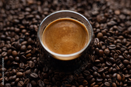 Coffee cup and coffee beans on a dark background. Close up.