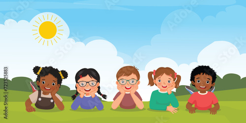 Group of multi ethnic kids lying on the grass together
