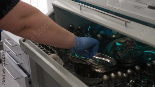 4K video. A nurse sterilizes dental medical instruments in an autoclave. Sterilization department of the dental clinic photo