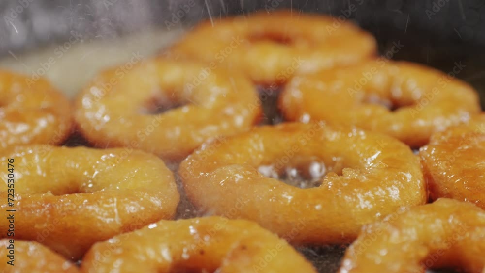 Fried crispy onion rings in a frying pan with oil close-up macro. Roasted onion rings for snacks at bar, cafe. Fast food. Delivery. Beer snacks Fried crispy onion rings in a frying pan with oil close-up macro. Roasted onion rings for snacks at bar, cafe. Fast food. Delivery. Beer snacks