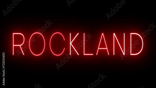 Flickering red retro style neon sign glowing against a black background for ROCKLAND photo