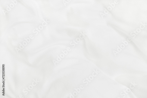 Texture of white blanket and bedding sheet with crumpled or messy in bedroom after wake up. photo