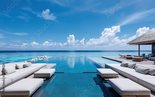 Modern pool that seems to merge with the boundless seascape. © Nattadesh