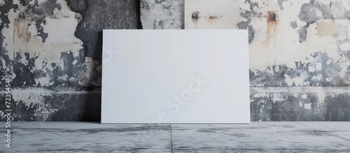 Text or design can be added on blank white poster against a grunge wall.