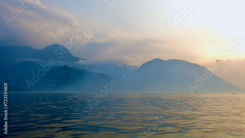 Tropical island at dawn. A hilly tropical island shrouded in fog during sunrise.