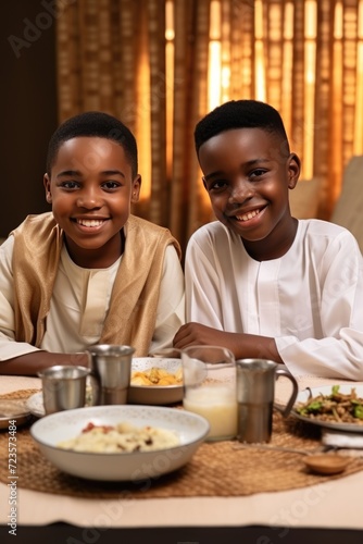 Two Children Smiling and Posing for a Photo at a Table