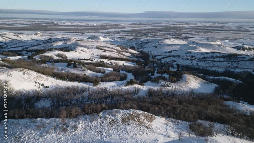 Stunning Aerial Flyover Rolling Snow Covered Hills of Huff Hills Ski Resort in Winter in Mandan, North Dakota, USA.