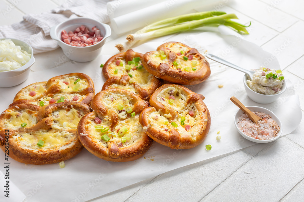 Homemade delicious traditional Bavarian Brezeln or pretzels baked with cream cheese, bacon and onions
